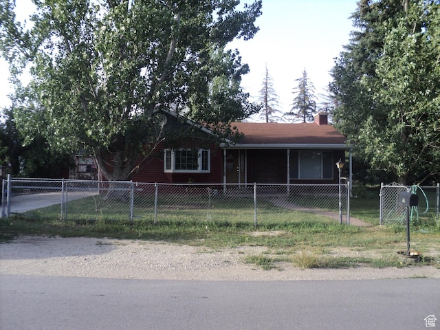 view of front of property featuring a fenced front yard and a chimney