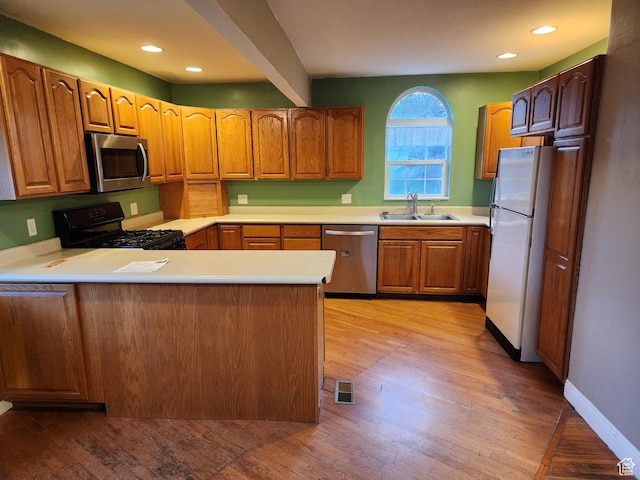 50 W 250 N, Midway, UT 84049 - kitchen with a sink, light countertops, stainless steel appliances, light wood-style flooring, and a peninsula