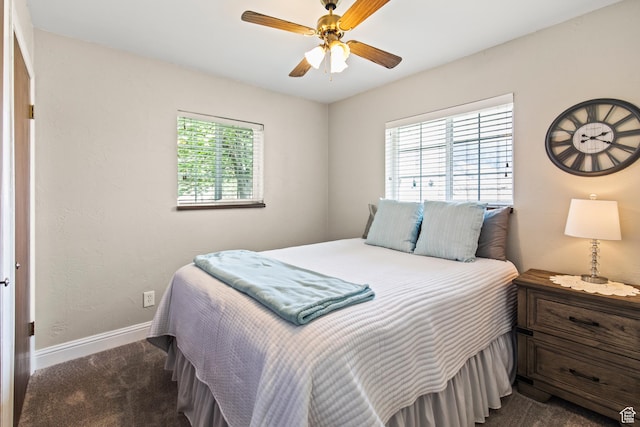 bedroom with a ceiling fan, baseboards, and dark carpet