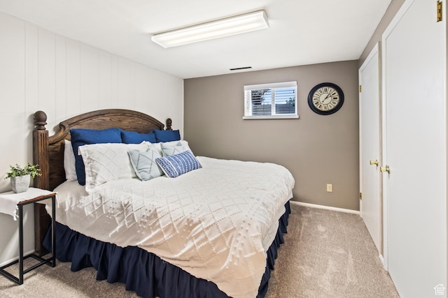 carpeted bedroom featuring baseboards and visible vents