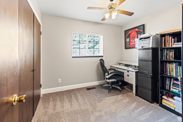 carpeted office space with visible vents, baseboards, and a ceiling fan