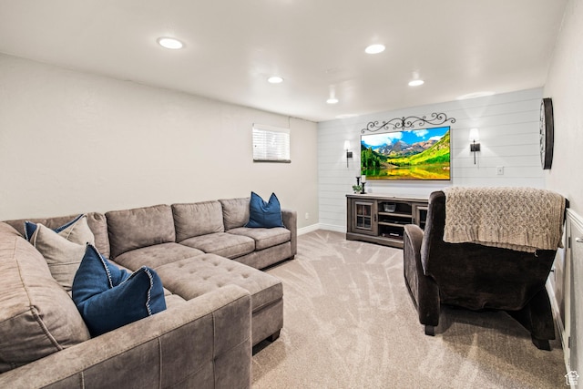 living room with recessed lighting, baseboards, wood walls, and light carpet