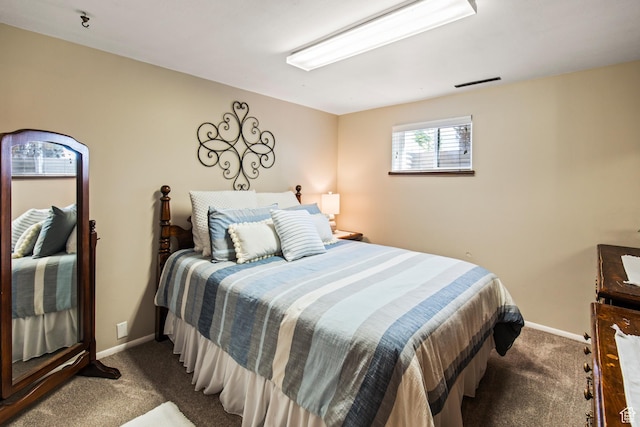 carpeted bedroom with baseboards and visible vents