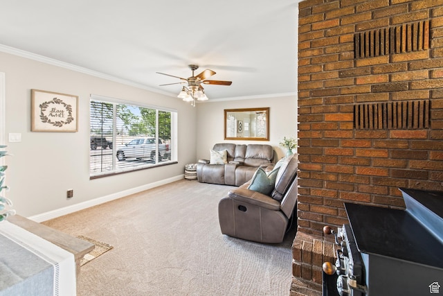 carpeted living room featuring baseboards, ornamental molding, and a ceiling fan
