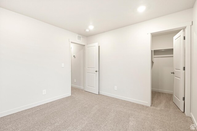 1264 N Berra Blvd Unit 133, Tooele, UT 84074 - unfurnished bedroom featuring carpet floors, visible vents, baseboards, a walk in closet, and recessed lighting