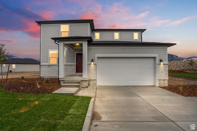 1264 N Berra Blvd Unit 133, Tooele, UT 84074 - traditional-style house with concrete driveway, a lawn, brick siding, and a garage