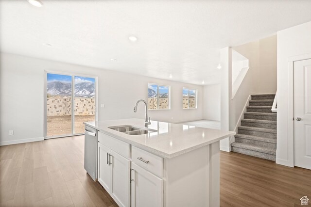 1264 N Berra Blvd Unit 133, Tooele, UT 84074 - kitchen featuring light stone countertops, a sink, light wood finished floors, white cabinetry, and stainless steel dishwasher
