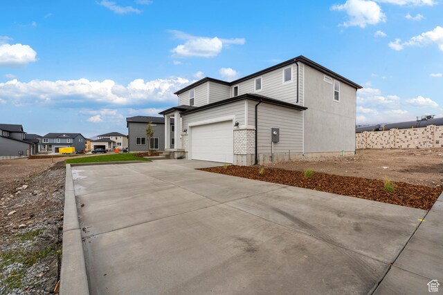 1264 N Berra Blvd Unit 133, Tooele, UT 84074 - view of property exterior with a garage, concrete driveway, and a residential view