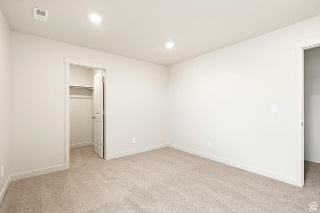 1264 N Berra Blvd Unit 133, Tooele, UT 84074 - unfurnished bedroom featuring visible vents, recessed lighting, a spacious closet, and light colored carpet