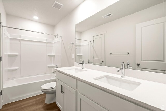1264 N Berra Blvd Unit 133, Tooele, UT 84074 - bathroom with visible vents, a sink, wood finished floors, and toilet