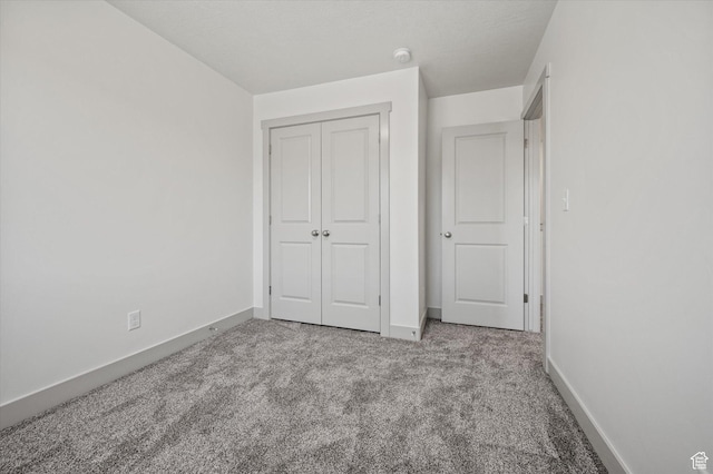 658 S 85 E Unit 13, Smithfield, UT 84335 - unfurnished bedroom featuring carpet floors, a closet, and baseboards