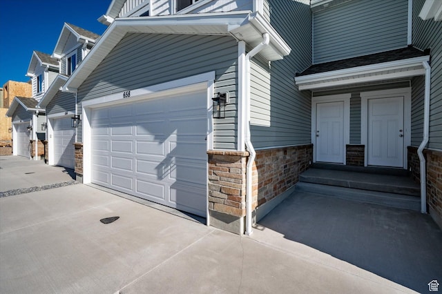 658 S 85 E Unit 13, Smithfield, UT 84335 - property entrance featuring concrete driveway and stone siding