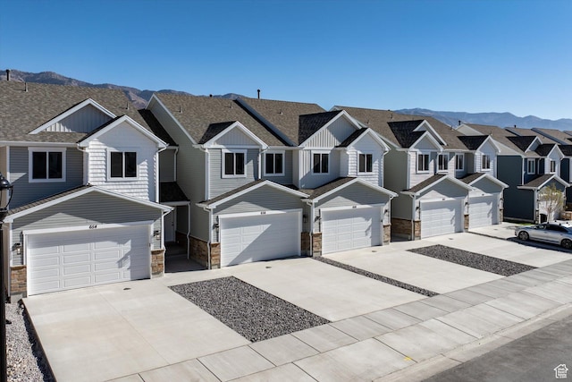 658 S 85 E Unit 13, Smithfield, UT 84335 - view of property featuring stone siding, a mountain view, and concrete driveway