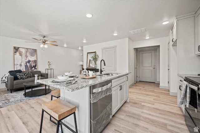 658 S 85 E Unit 13, Smithfield, UT 84335 - kitchen with a sink, stainless steel dishwasher, range with electric cooktop, a ceiling fan, and a kitchen bar