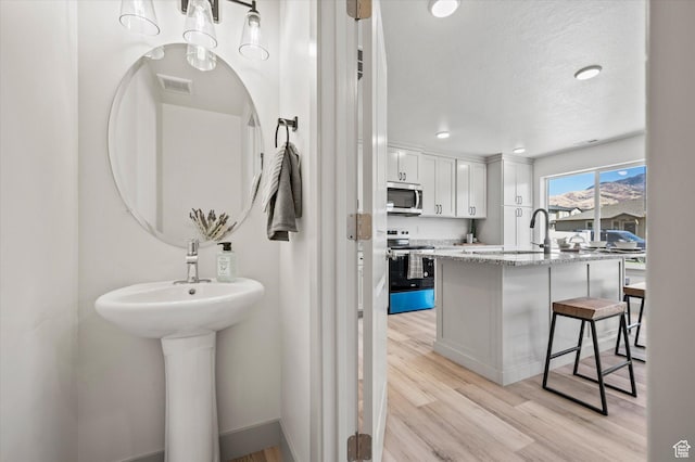 658 S 85 E Unit 13, Smithfield, UT 84335 - bathroom featuring wood finished floors and a sink
