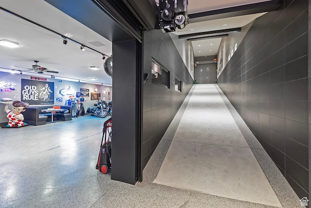 corridor featuring speckled floor