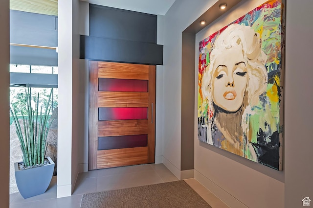 entryway with tile patterned flooring and baseboards