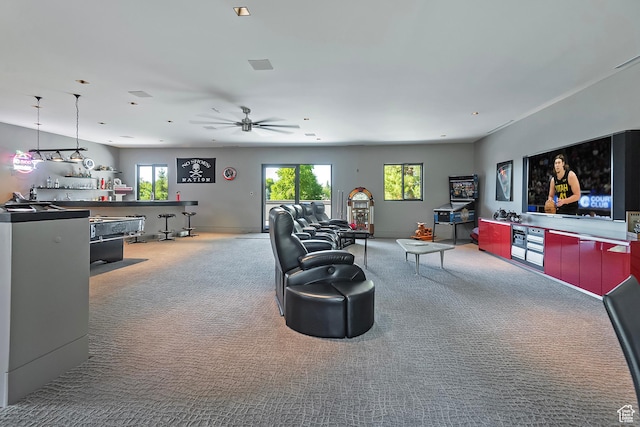carpeted living area featuring plenty of natural light and ceiling fan