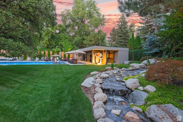 view of yard with an outdoor pool, an outdoor structure, and a patio