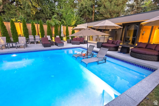 view of swimming pool with a fenced in pool, a patio area, fence, and an outdoor living space