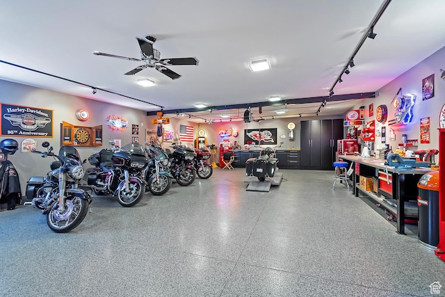 garage featuring a workshop area and a ceiling fan