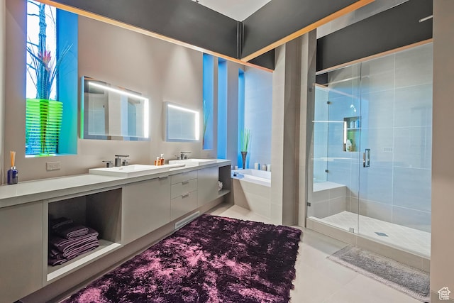 bathroom featuring double vanity, a sink, a shower stall, tile patterned flooring, and a bath