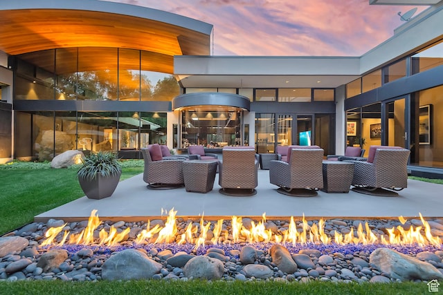 exterior space featuring a patio area and an outdoor living space with a fire pit