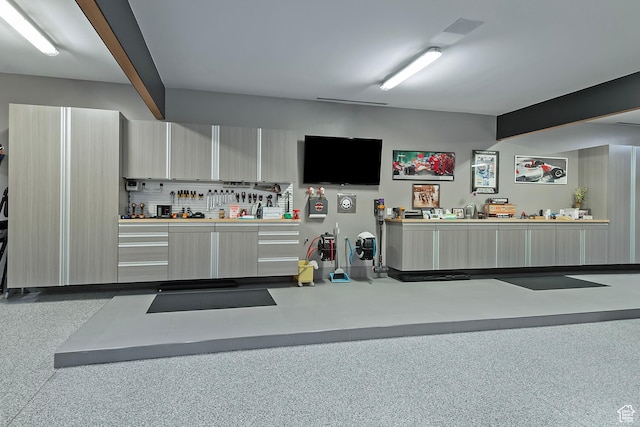 interior space with speckled floor and beamed ceiling
