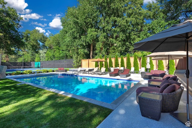 view of pool featuring outdoor lounge area, fence, a lawn, a fenced in pool, and a patio area
