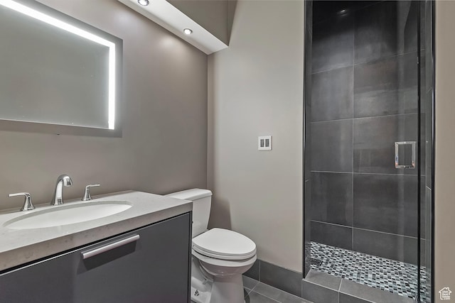 full bathroom featuring vanity, a shower stall, toilet, and tile patterned floors