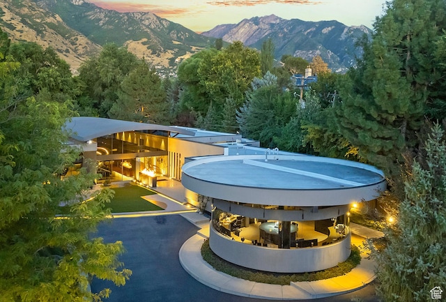 pool at dusk featuring a mountain view