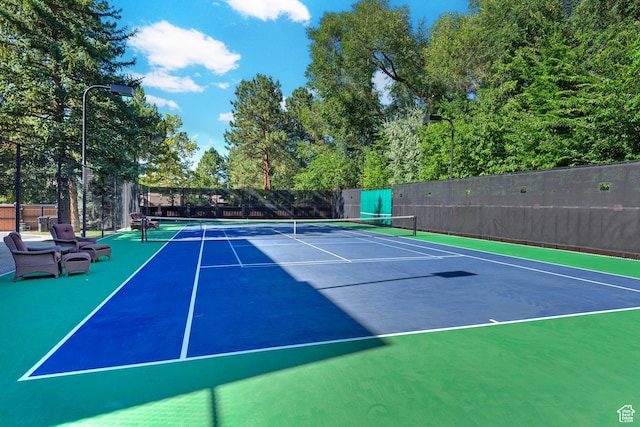view of tennis court featuring fence