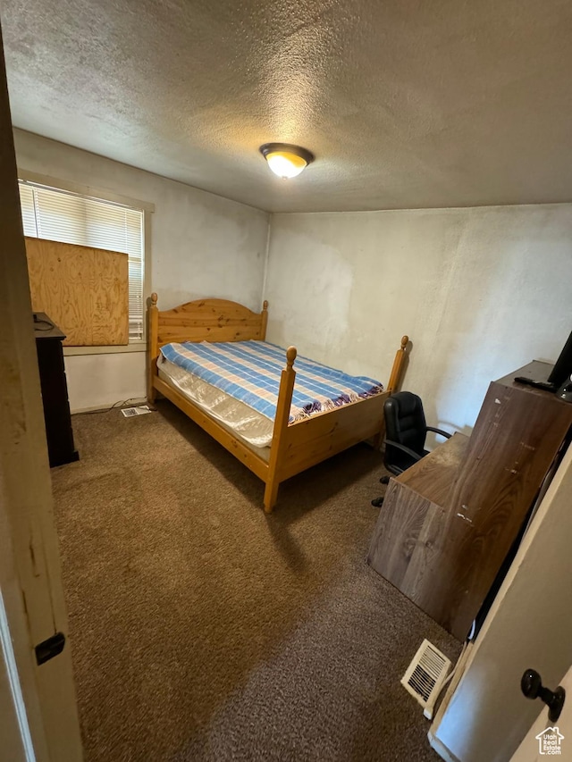 320 N Stone Rd, Snowville, UT 84336 - carpeted bedroom with a textured ceiling
