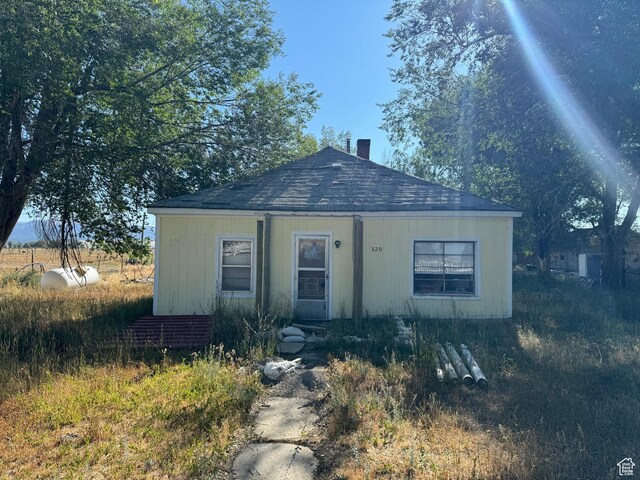 320 N Stone Rd, Snowville, UT 84336 - bungalow featuring roof with shingles and a chimney