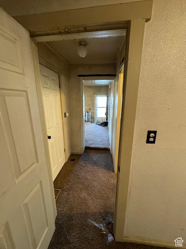 320 N Stone Rd, Snowville, UT 84336 - corridor featuring dark carpet and a textured wall