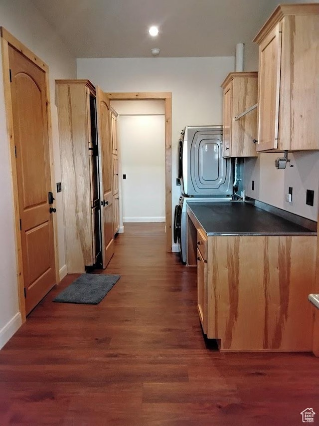 630 W 150 S, Torrey, UT 84775 - kitchen featuring stacked washer / drying machine, light brown cabinets, dark countertops, baseboards, and dark wood-style flooring