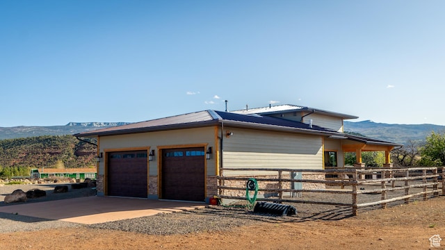 630 W 150 S, Torrey, UT 84775 - view of home's exterior featuring a mountain view, dirt driveway, a garage, metal roof, and an exterior structure