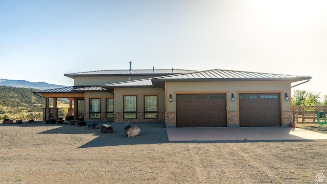 630 W 150 S, Torrey, UT 84775 - view of front of property featuring a standing seam roof, driveway, an attached garage, a mountain view, and fence