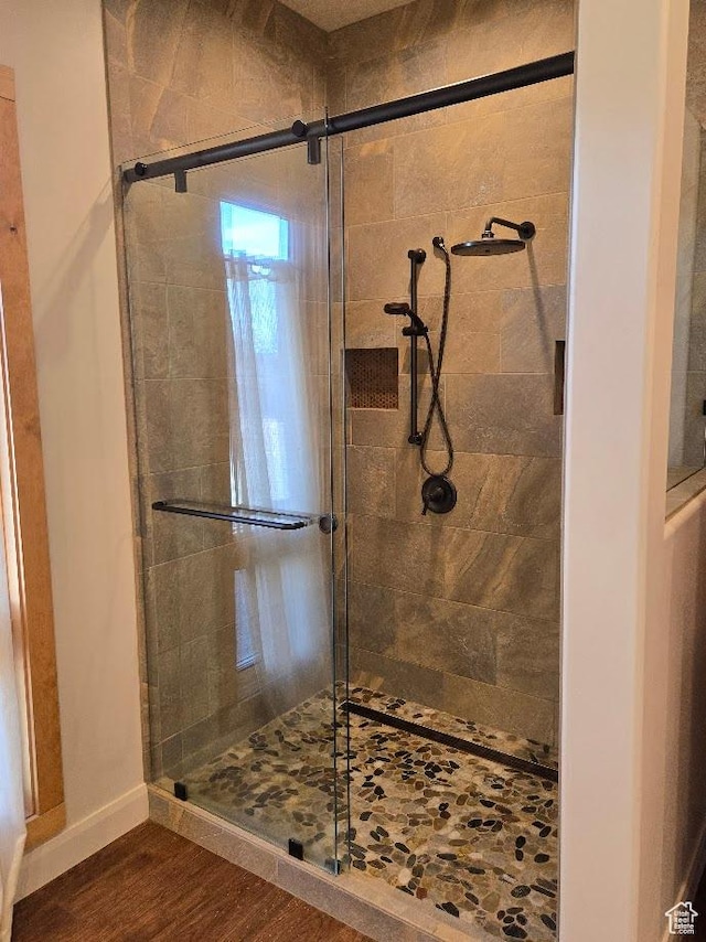 630 W 150 S, Torrey, UT 84775 - bathroom featuring a stall shower, wood finished floors, and baseboards