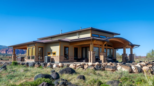 630 W 150 S, Torrey, UT 84775 - back of property featuring cooling unit, a mountain view, metal roof, and stone siding