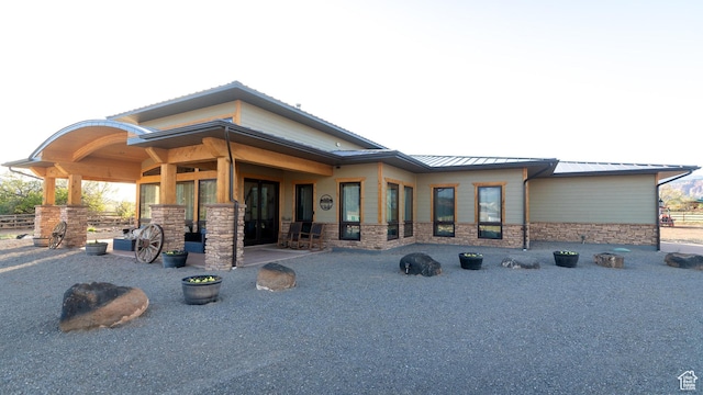 630 W 150 S, Torrey, UT 84775 - rear view of house featuring a standing seam roof, stone siding, and metal roof