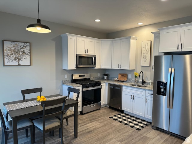 165 E 700 N Unit 13, Ephraim, UT 84627 - kitchen with recessed lighting, light wood-style flooring, white cabinets, stainless steel appliances, and a sink