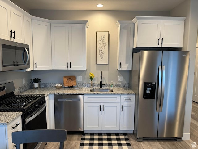 169 E 700 N Unit 14, Ephraim, UT 84627 - kitchen with a sink, light wood-style floors, white cabinetry, and stainless steel appliances
