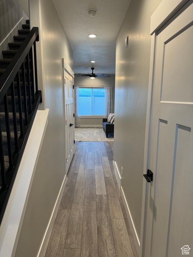 169 E 700 N Unit 14, Ephraim, UT 84627 - hallway featuring stairway, baseboards, visible vents, and dark wood finished floors