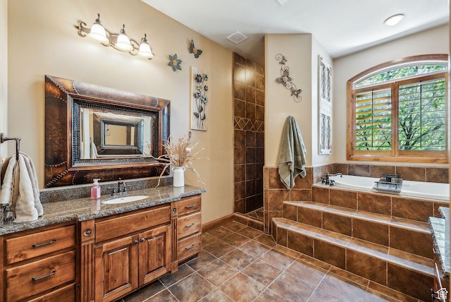 bathroom with tile patterned floors, vanity, and a bath