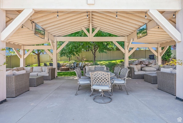 view of patio with a fenced backyard, an outdoor living space, a gazebo, and outdoor dining area