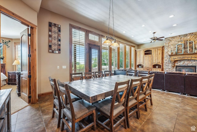 dining room featuring recessed lighting, light tile patterned floors, baseboards, a ceiling fan, and a fireplace