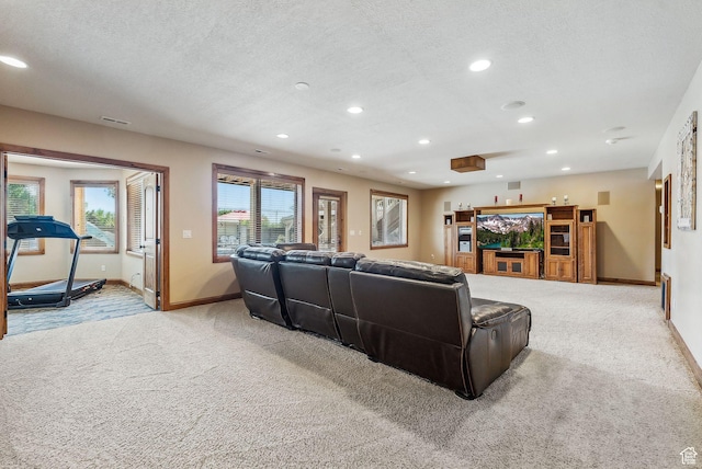 living area featuring light carpet, baseboards, and a textured ceiling