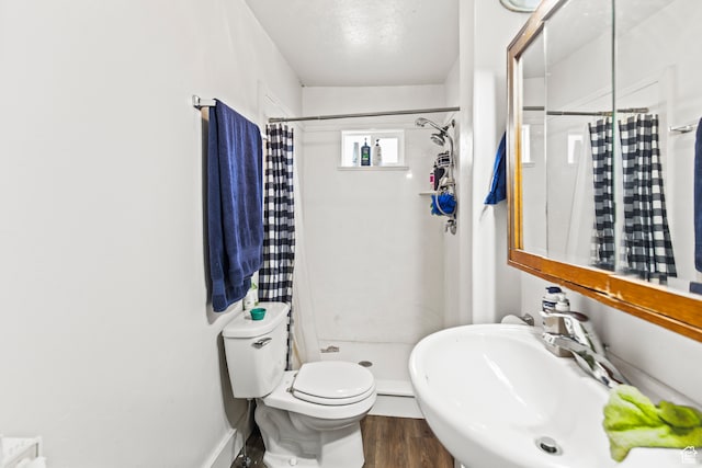 69 S Main St, Manti, UT 84642 - bathroom featuring curtained shower, wood-type flooring, toilet, and sink