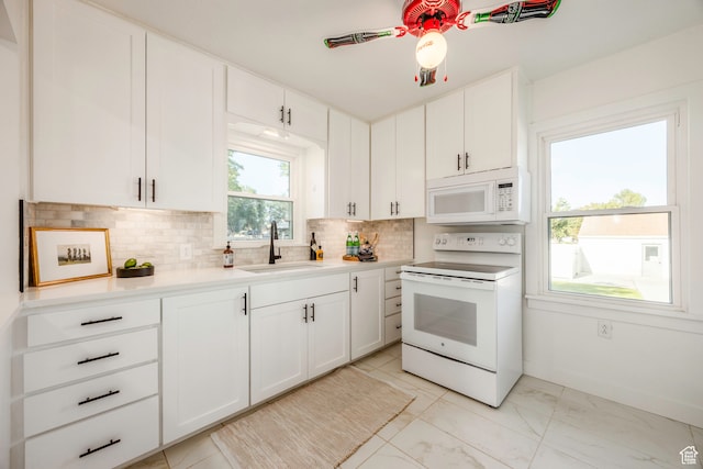 kitchen with white cabinetry, white appliances, light tile patterned floors, sink, and ceiling fan